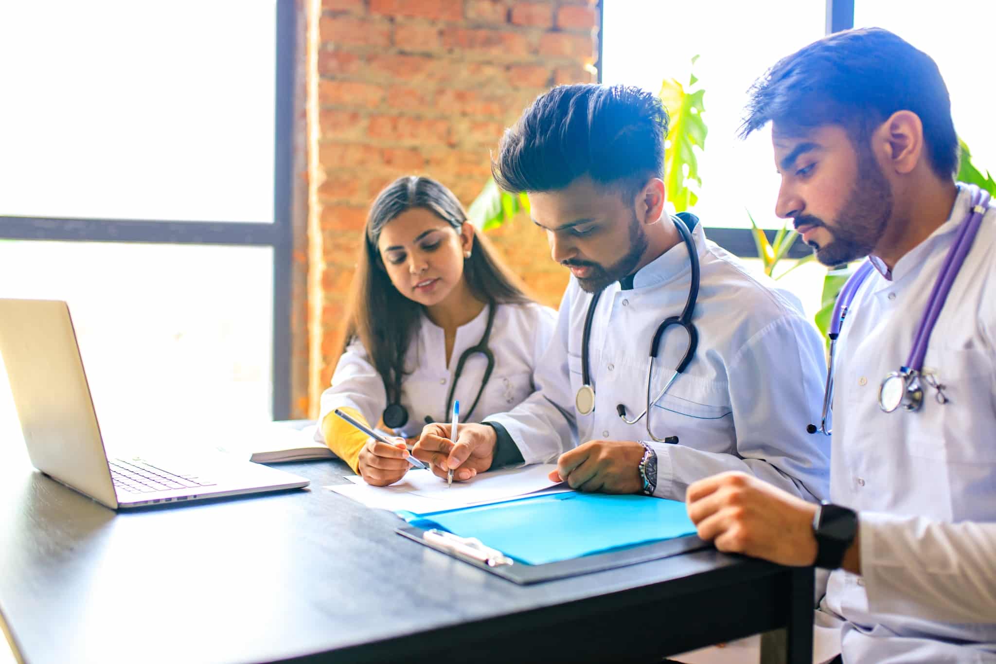 Medical students writing in notebooks